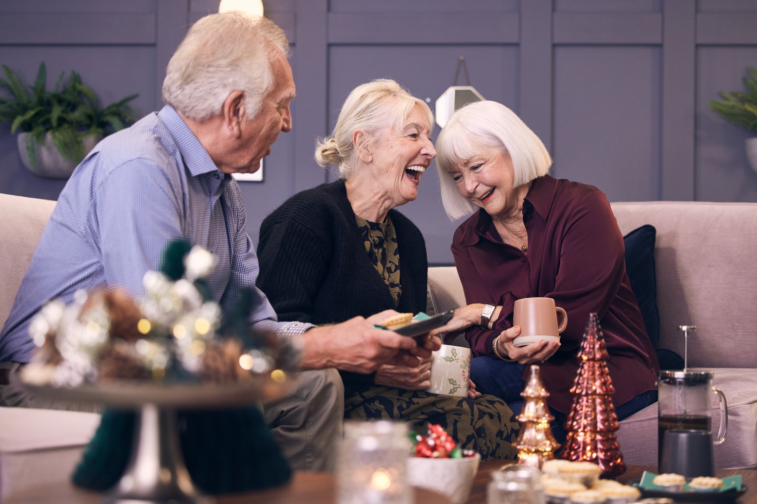 a group of people sitting at a table with food and drinks