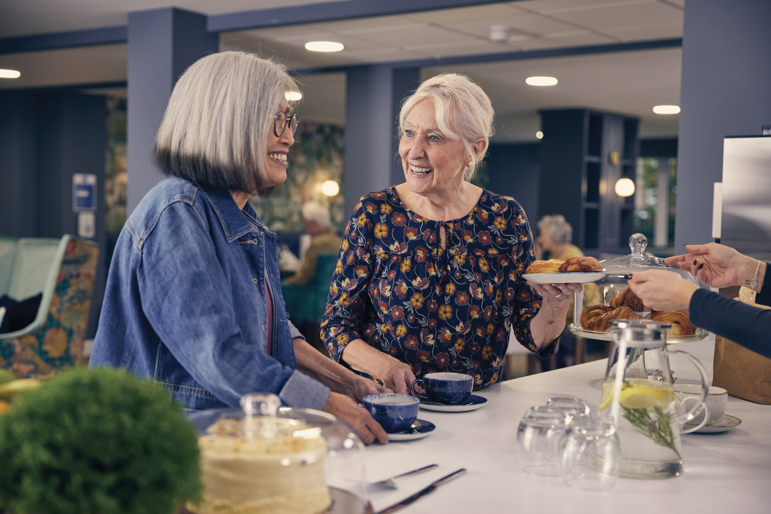 a couple of women eating at a table
