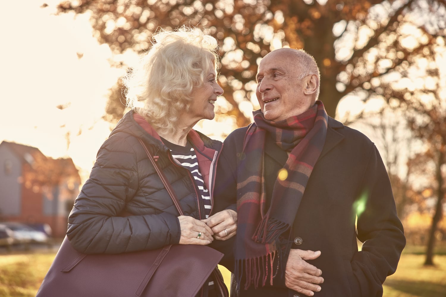 a man and woman standing next to each other and looking at each other