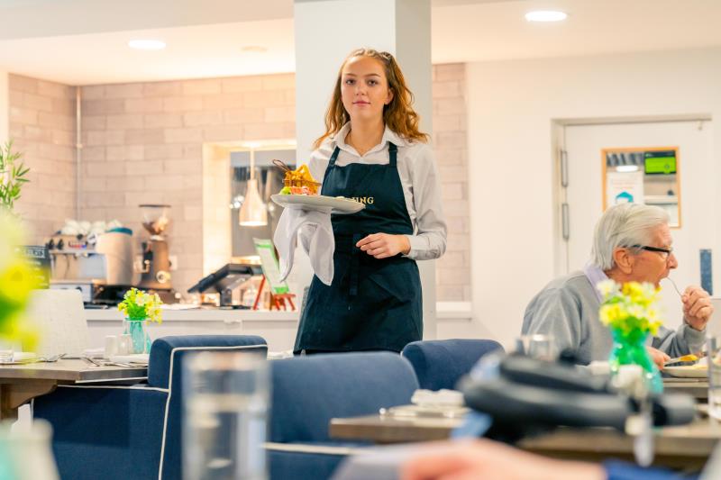 a woman holding a plate of food