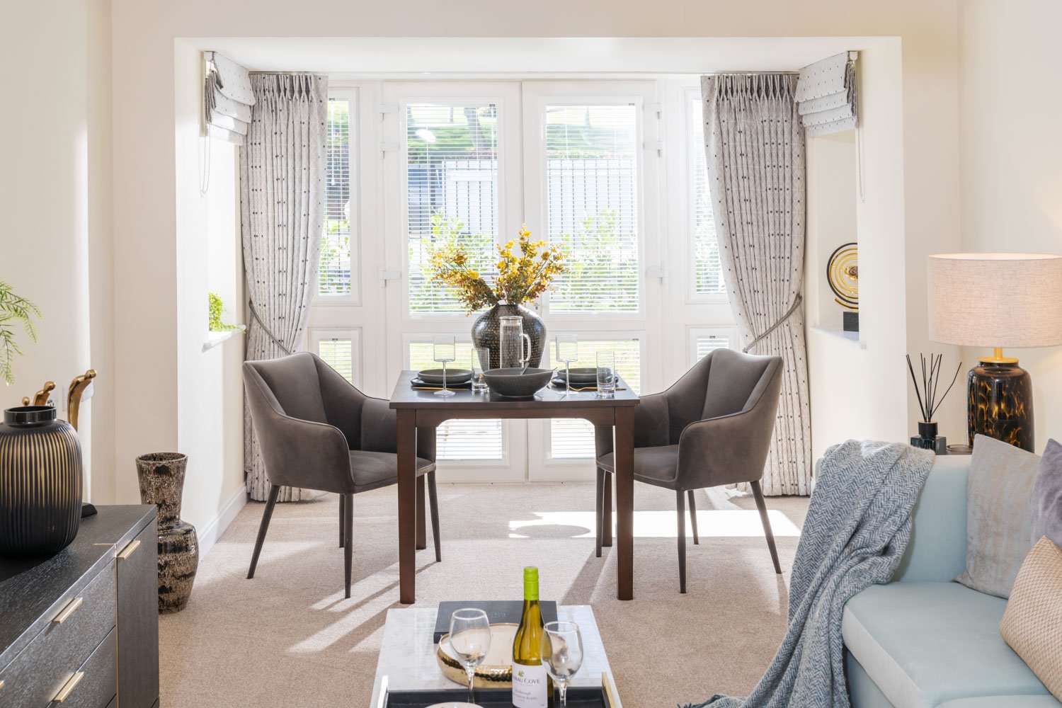a living room with a table and chairs