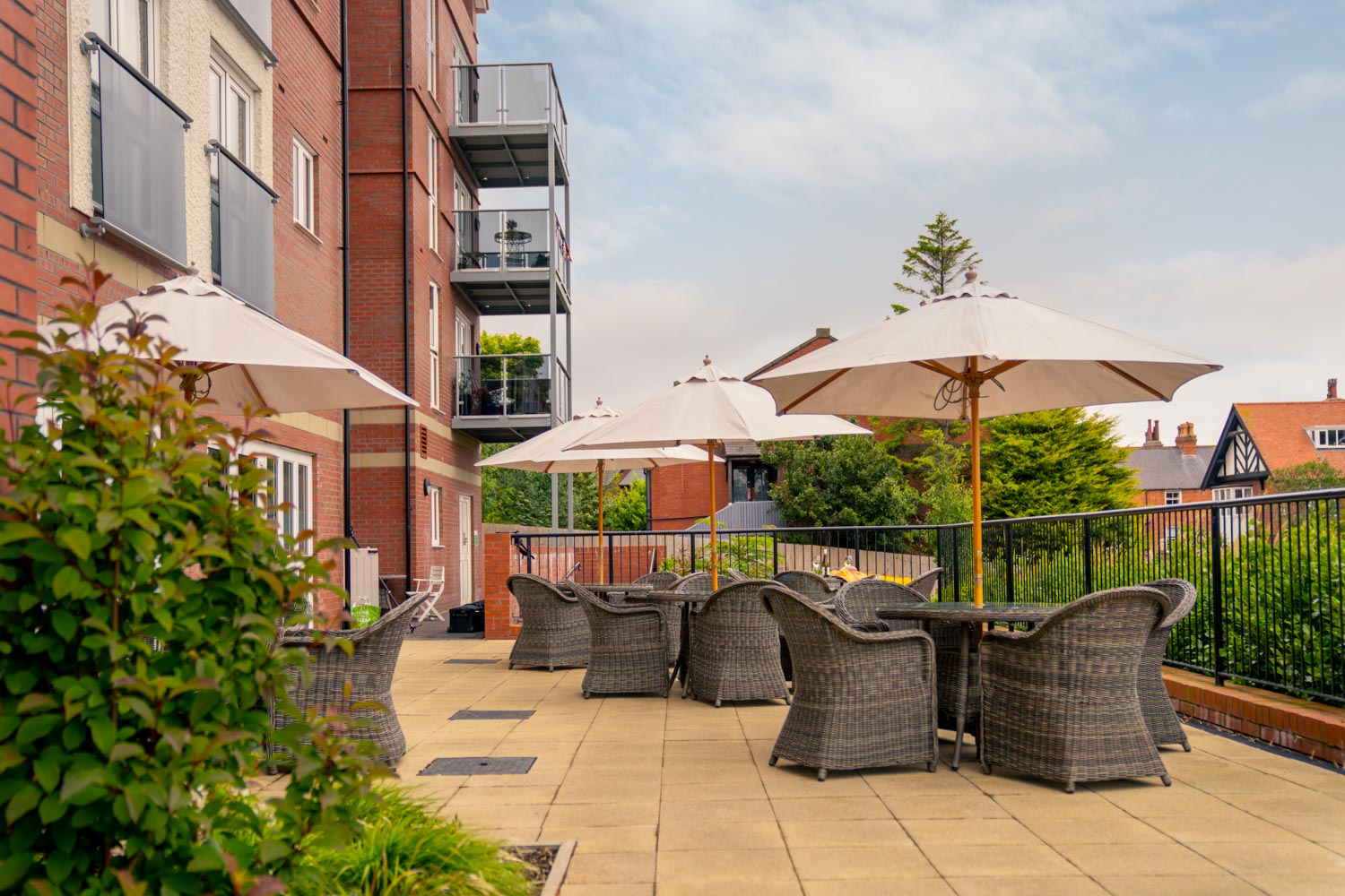a patio with chairs and umbrellas