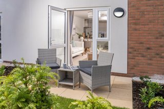 a patio with chairs and a table