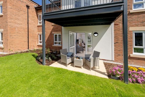 a house with a patio and a patio with a chair and a table