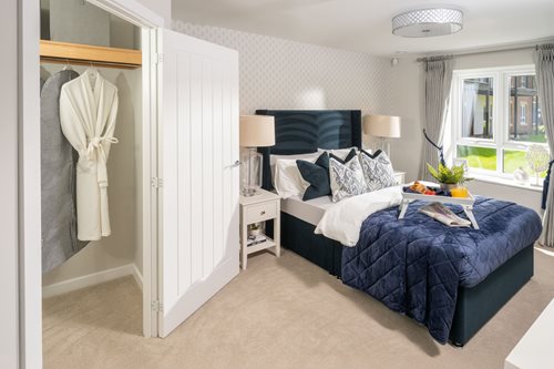 a bedroom with a bed and a lamp