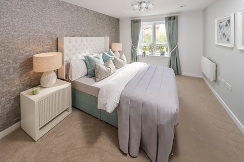 a bedroom with a bed and a lamp