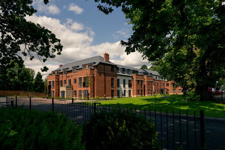 a large brick building with a fence around it