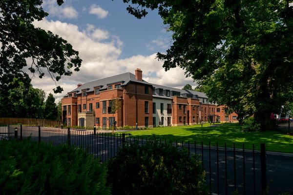 a large brick building with a fence around it