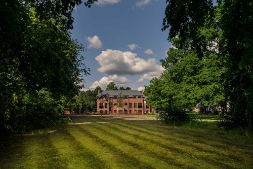 a large building with a lawn in front of it