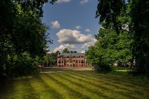 a large building with a lawn in front of it
