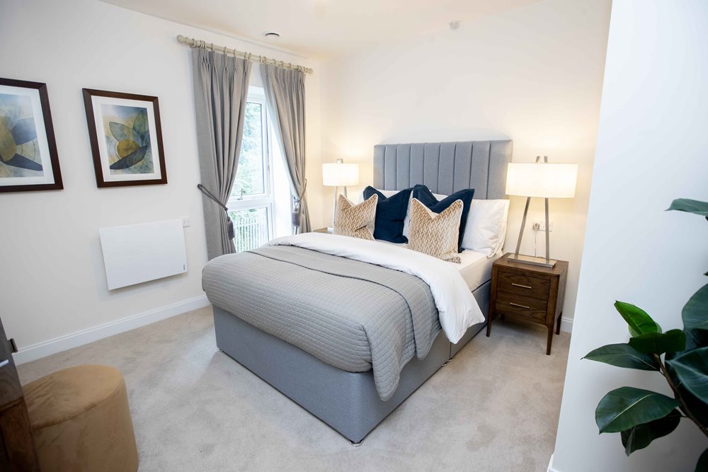 a bedroom with a bed and lamps