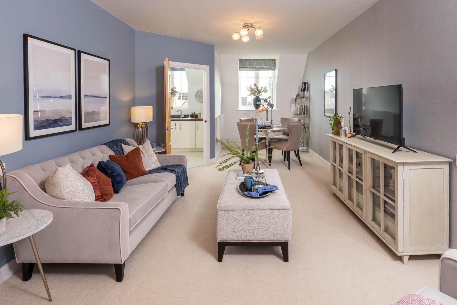 a living room with a white couch and a tv