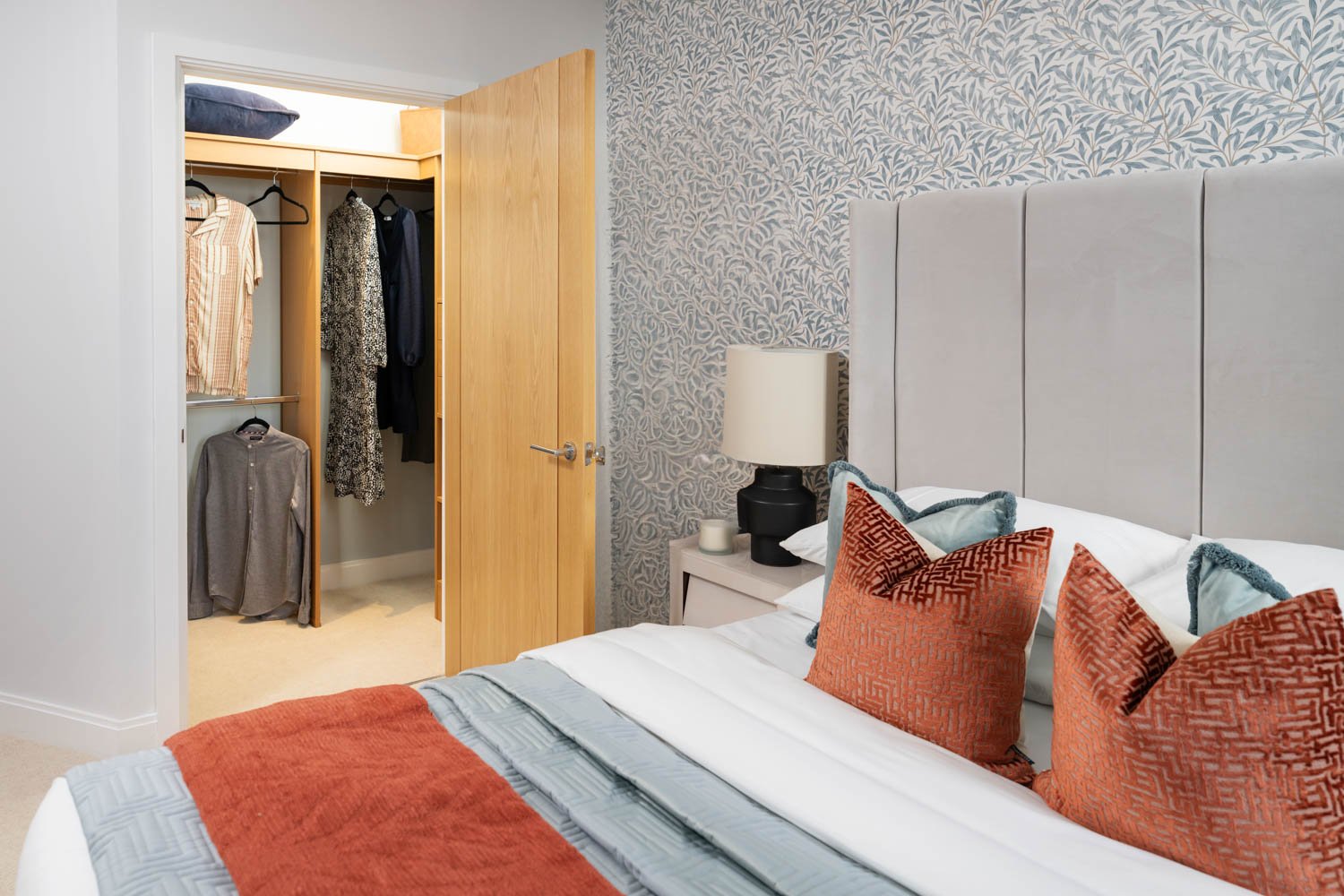 a bedroom with a bed and a lamp