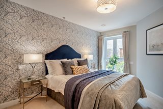 a bedroom with a bed and lamps