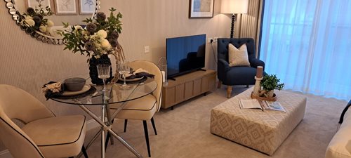 a living room with a table and chairs
