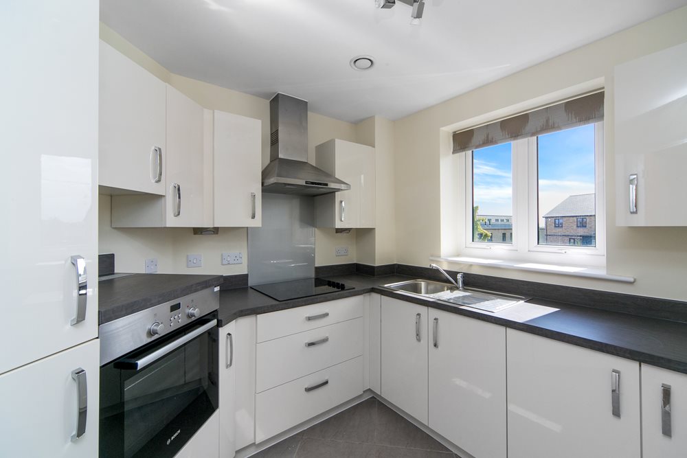 a kitchen with white cabinets