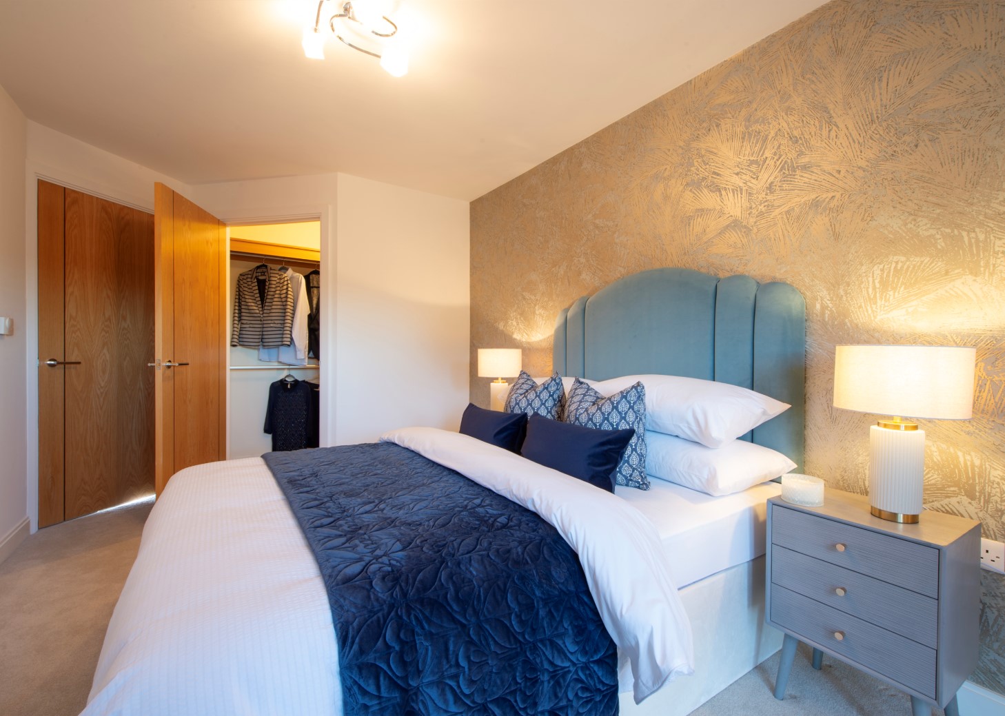 a bedroom with a bed and lamps