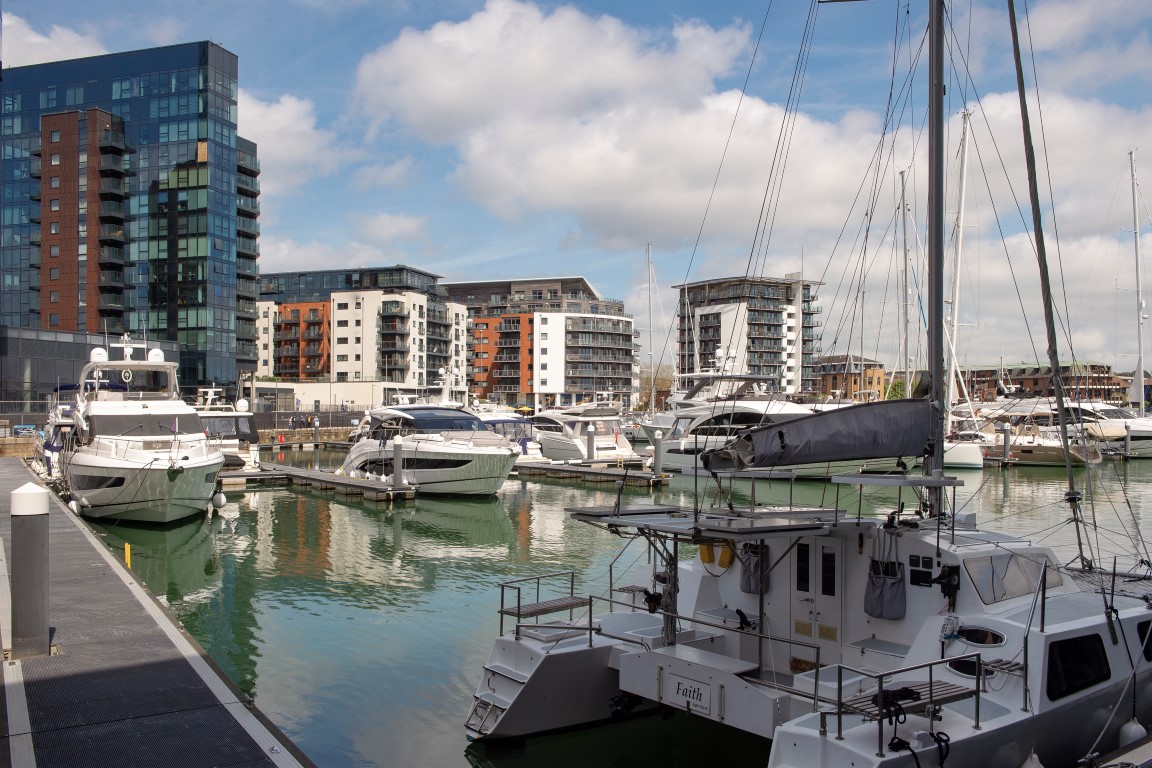 a marina with boats and buildings