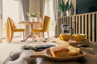 a table with a plate of food and a remote