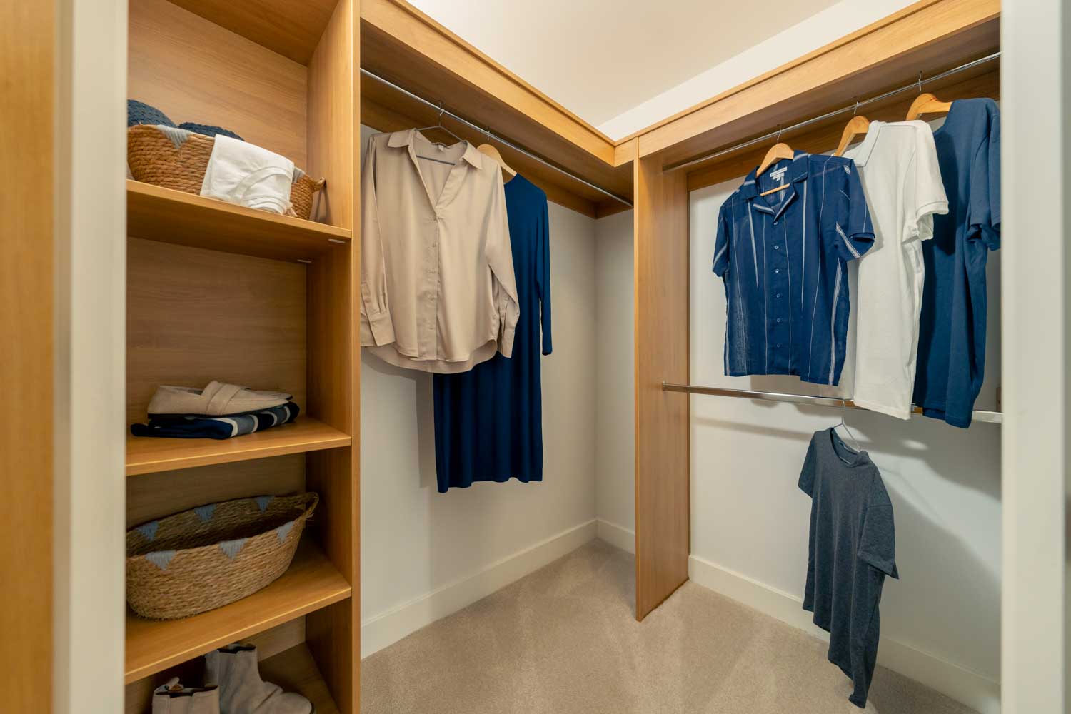a closet with clothes on the wall