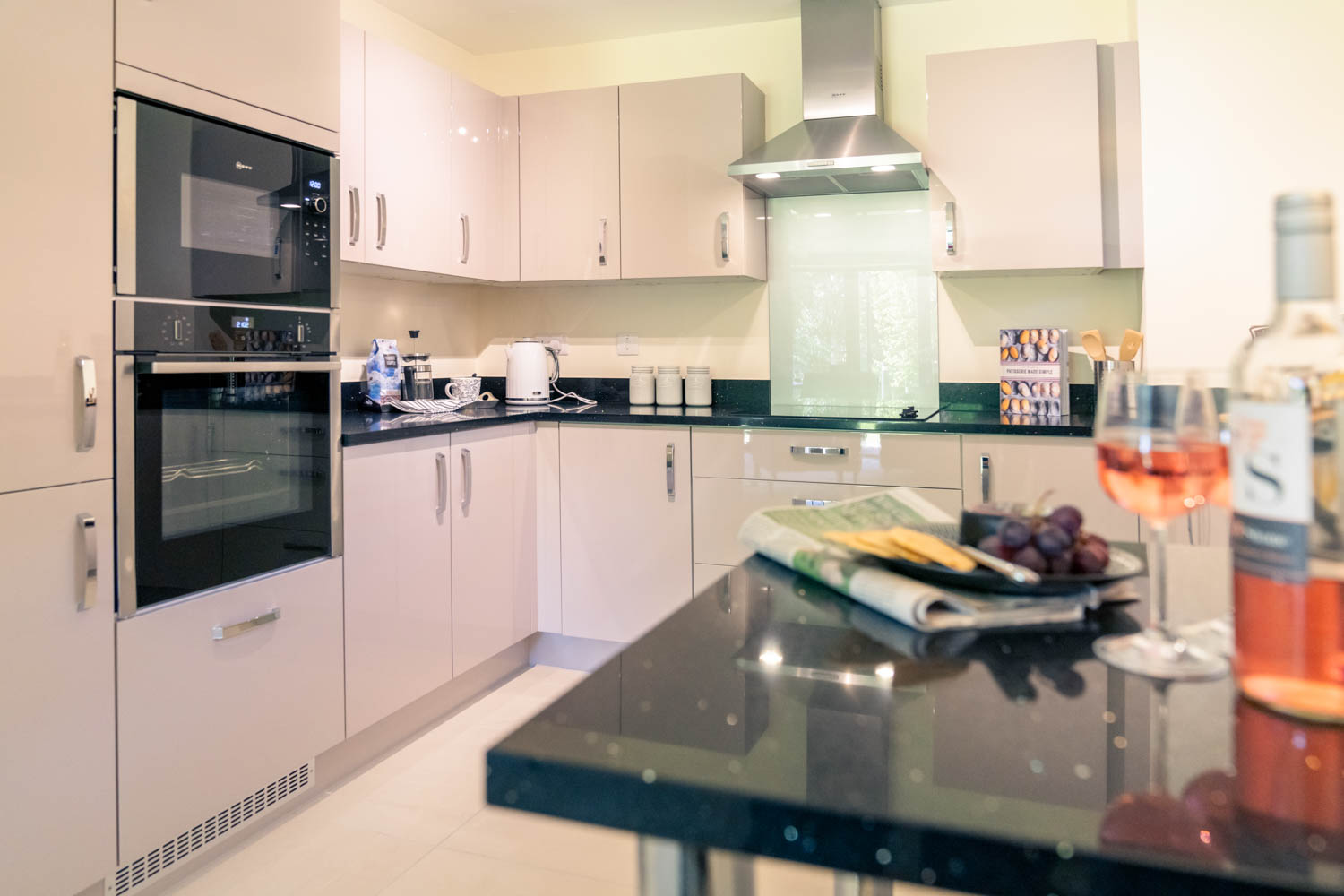 a kitchen with a glass of wine
