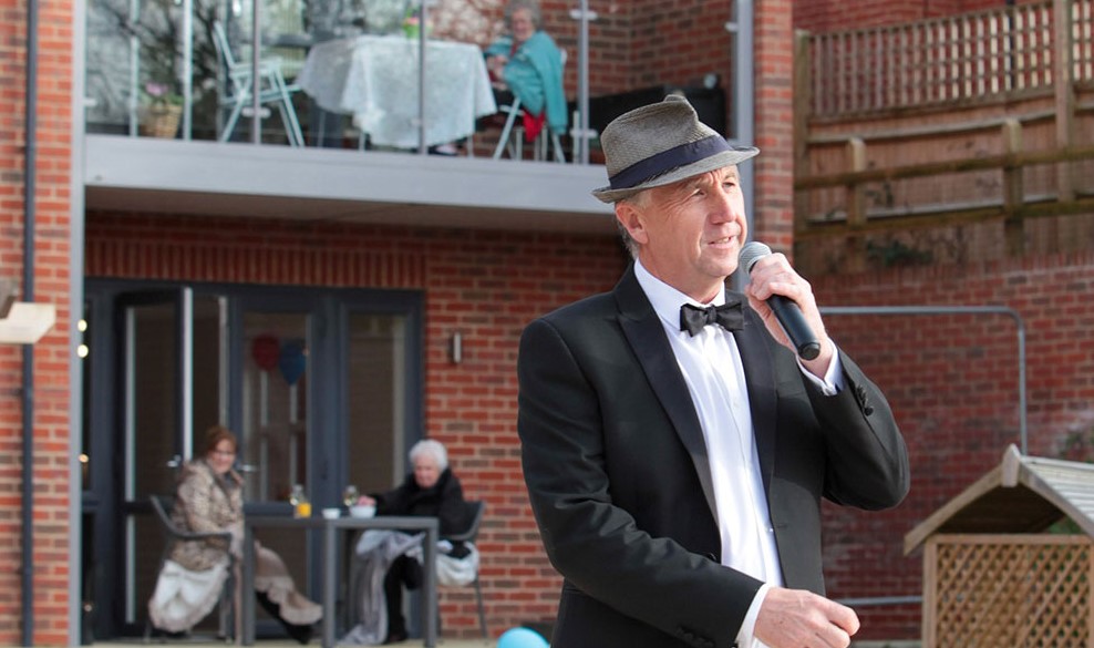 a man in a suit talking on a microphone
