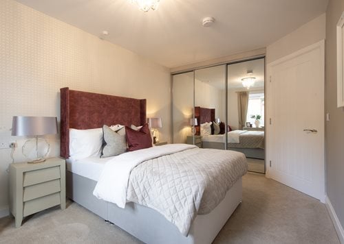 a bedroom with a large mirror
