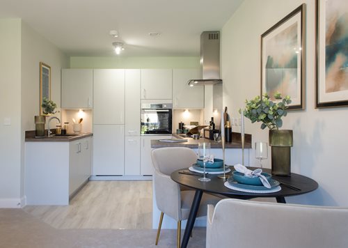 a kitchen with a dining table and chairs