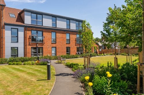 a building with a path and trees