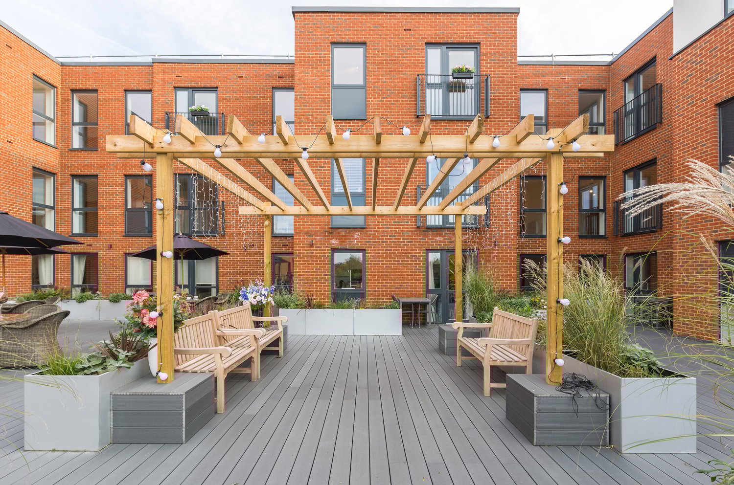 a brick building with tables and chairs outside