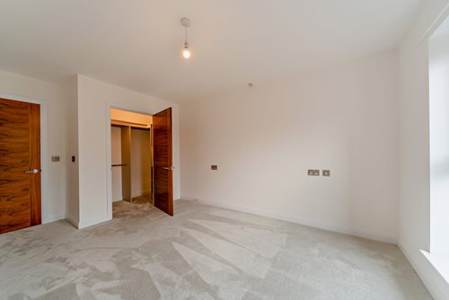 a hallway with a door and a carpet