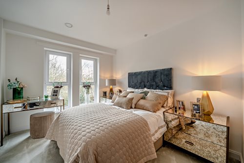 a bedroom with a bed and a desk