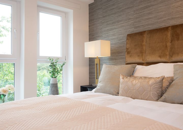a bed with a lamp on the side