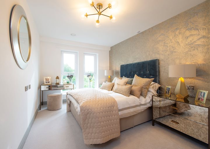 a bedroom with a bed and a mirror