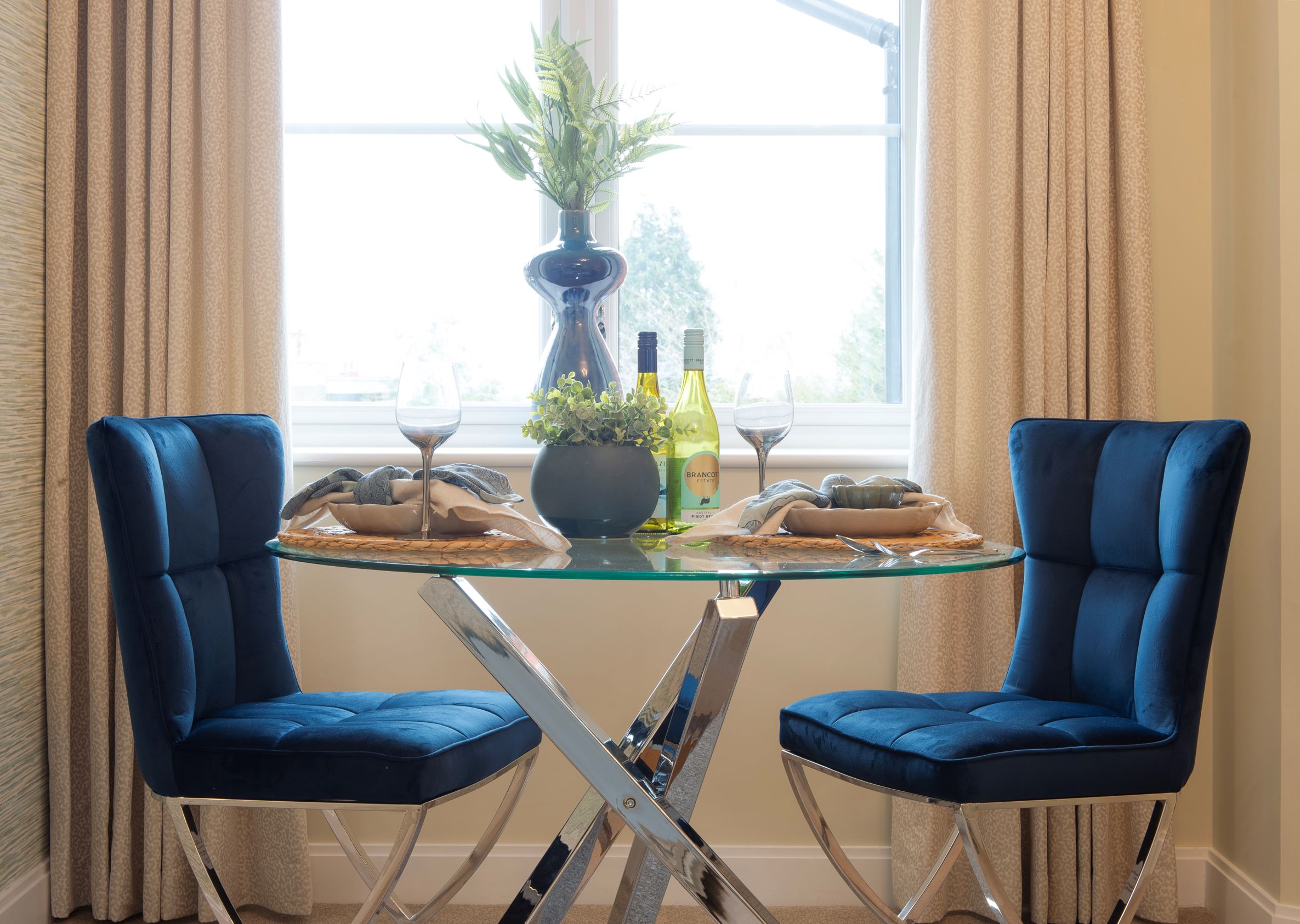 a table with chairs and glasses on it