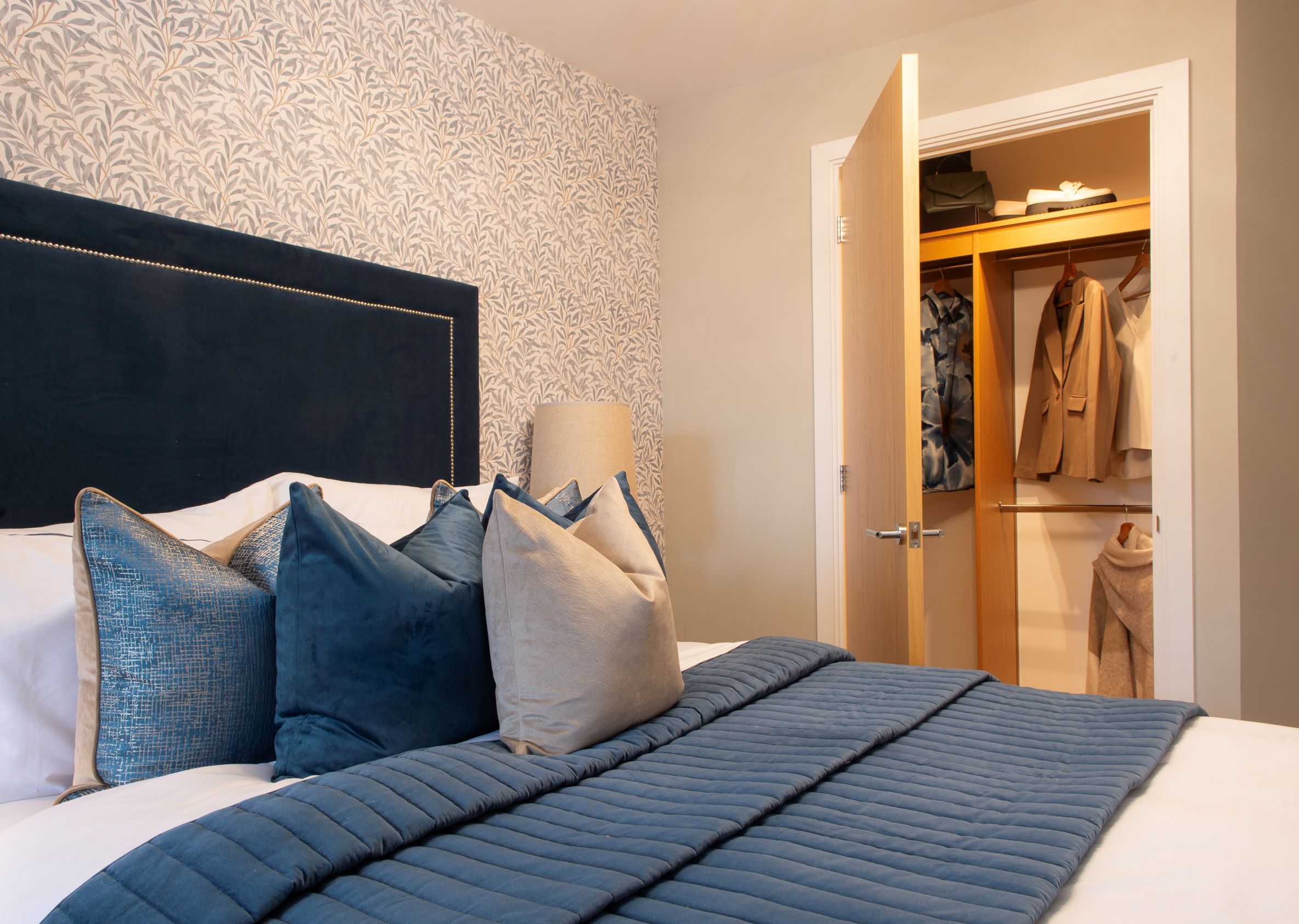 a bed with blue pillows