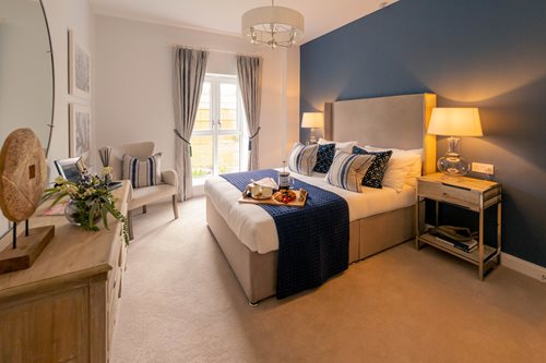 a bedroom with a bed and a chair