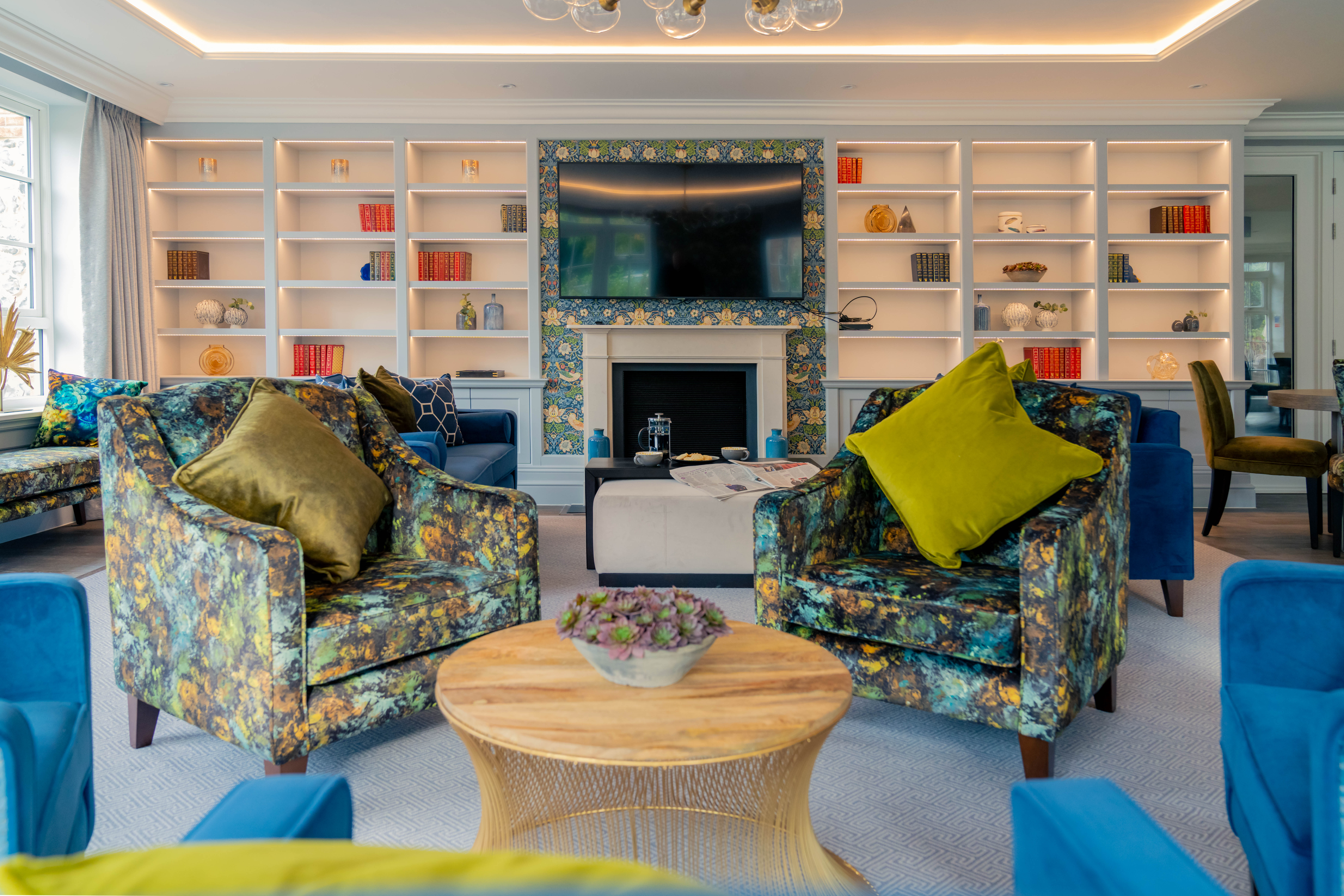 a living room with blue chairs