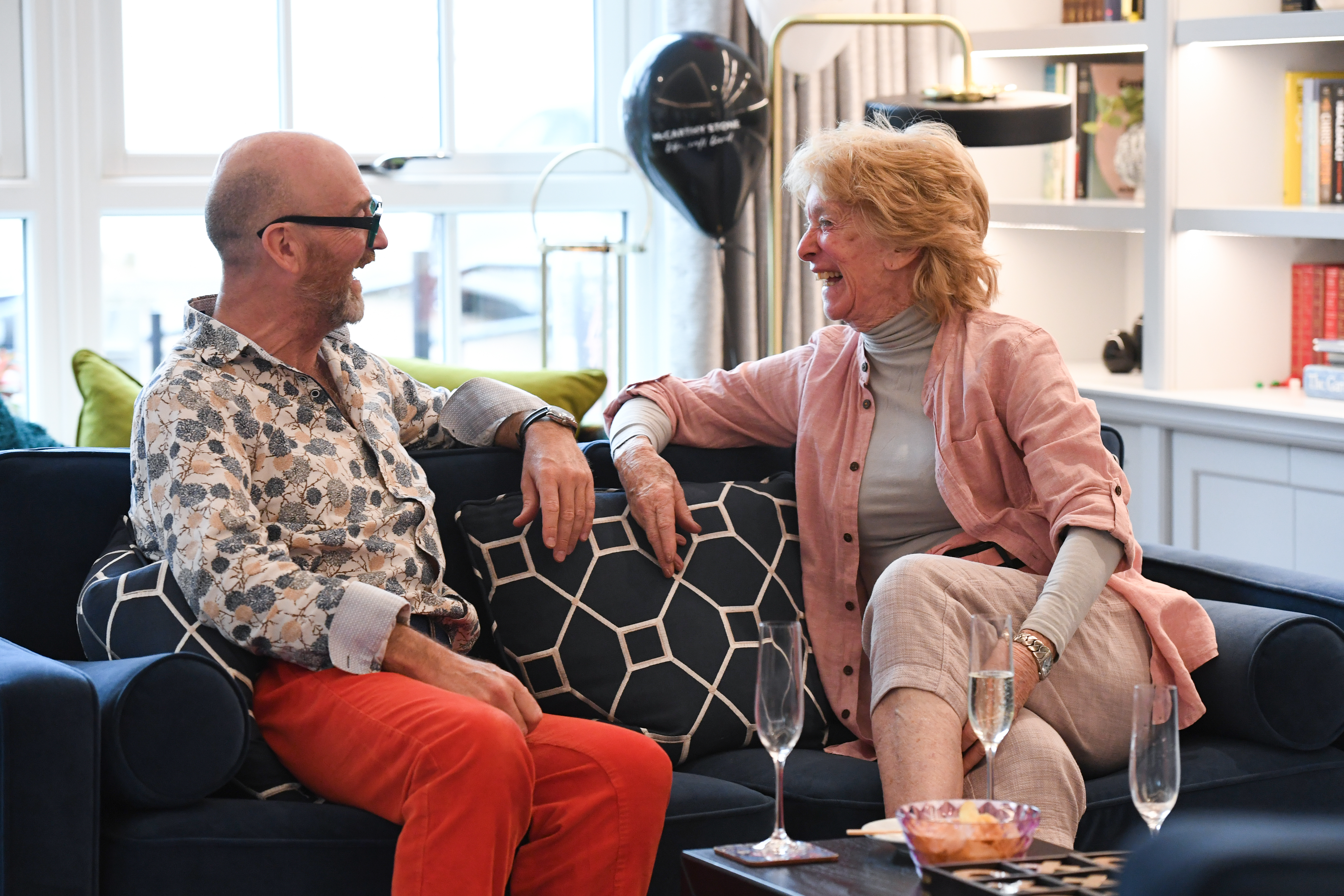 two people talking on a sofa 