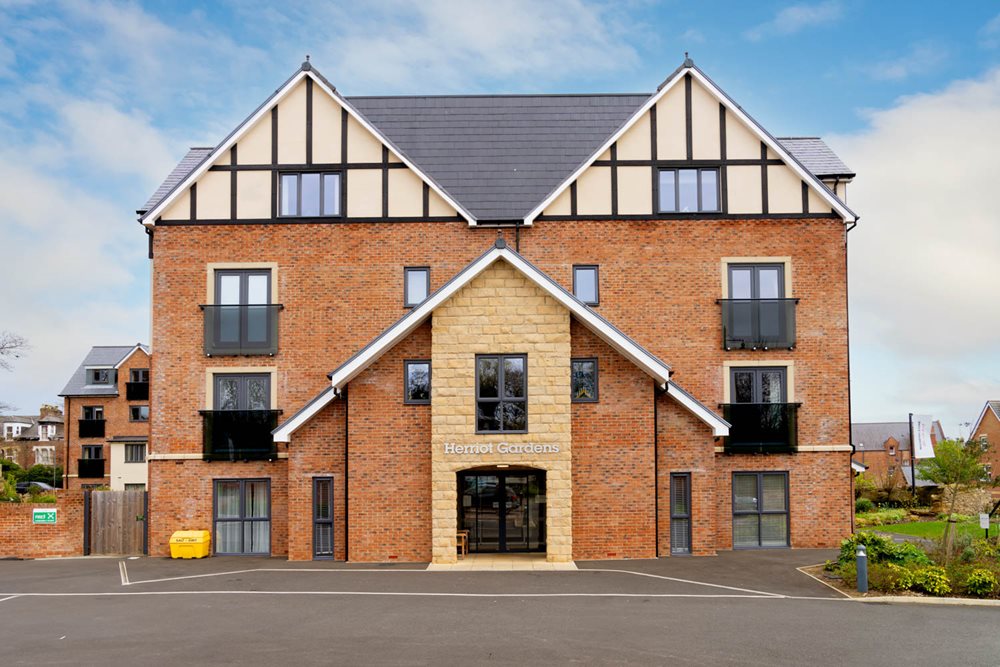 a brick building with a parking lot