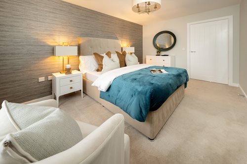 a bedroom with a bed and a chair