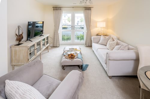 a living room with white furniture