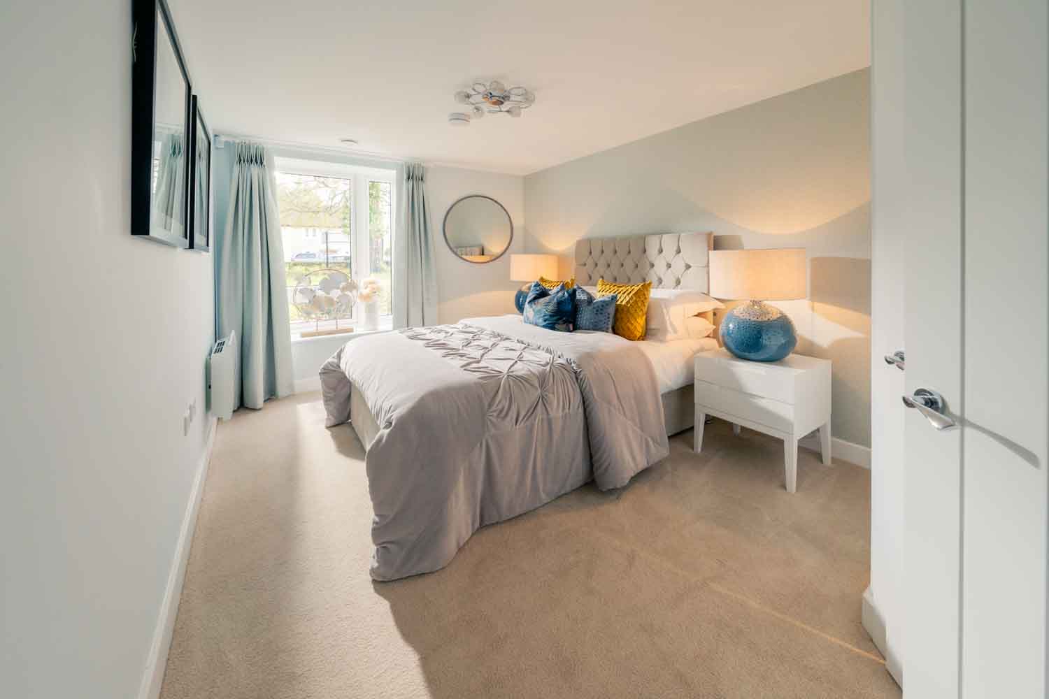 a bedroom with a bed and a mirror