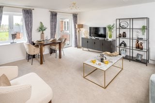 a living room with a table and chairs