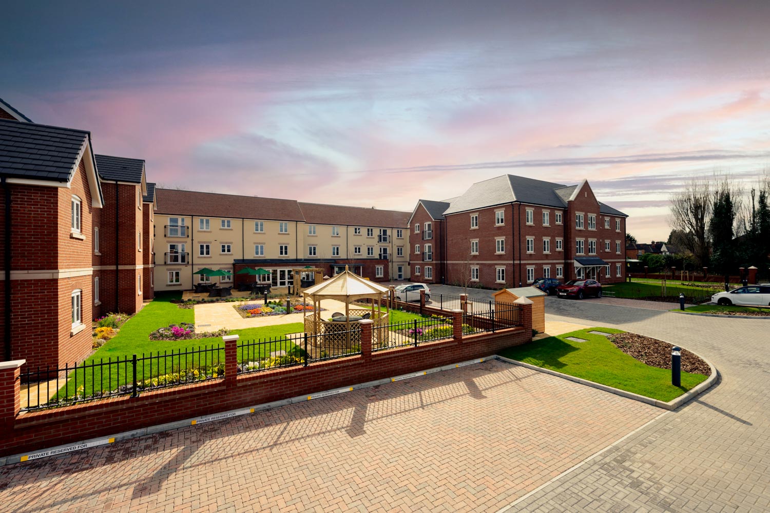 a brick walkway leading to a row of buildings
