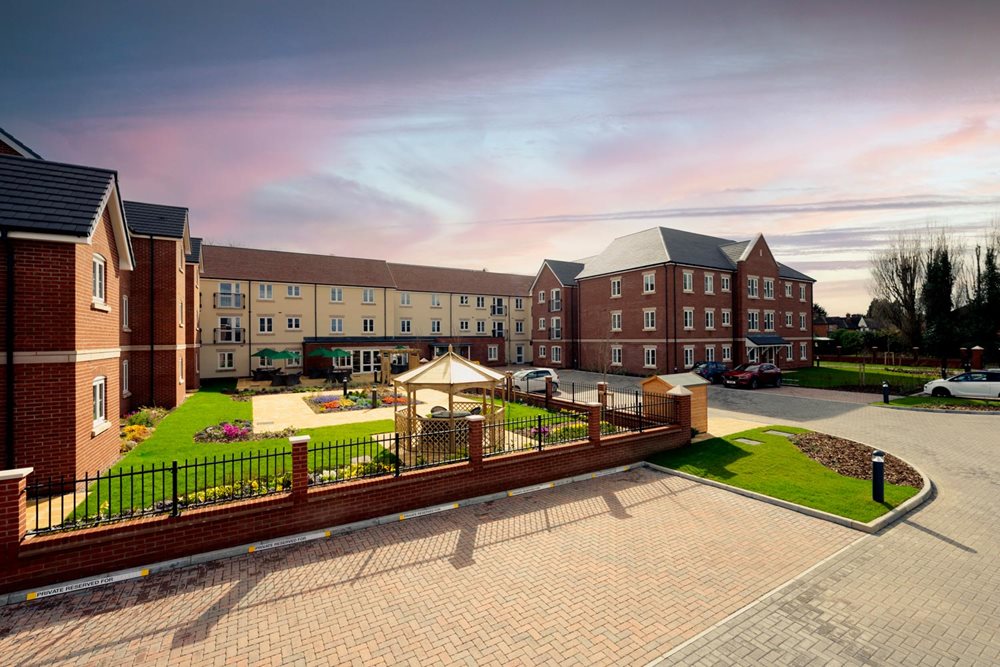 a brick walkway leading to a row of buildings
