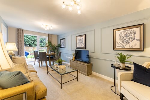 a living room with a tv and couches