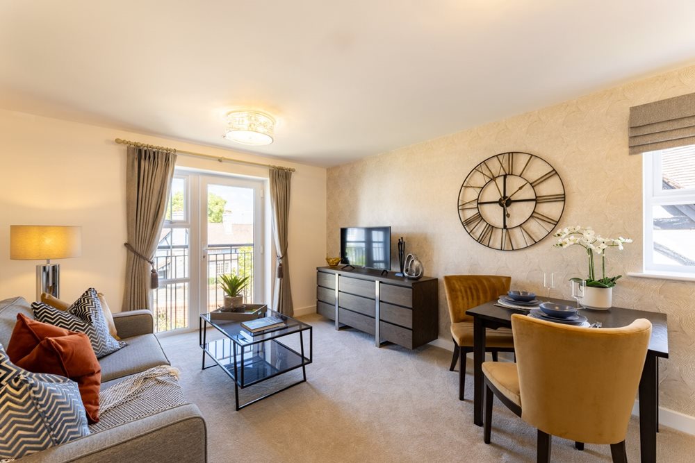 a living room with a round mirror