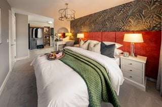 a bedroom with a bed and lamps