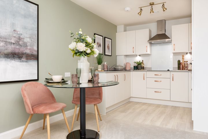 a kitchen with a table and chairs